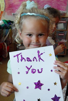 Little girl holding a sign saying thankyou