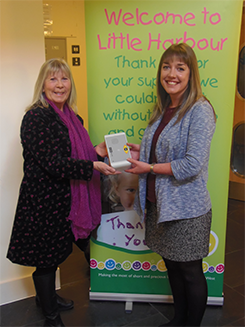 Caroline Swain accepts a RoomMate from ADi's, Helen Kemp on behalf of Children's Hospice South West